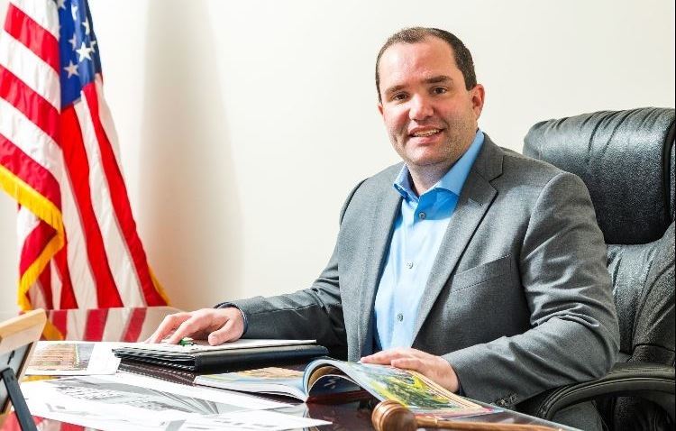 Mayor Dave Guerin sitting behind his desk at Village Hall