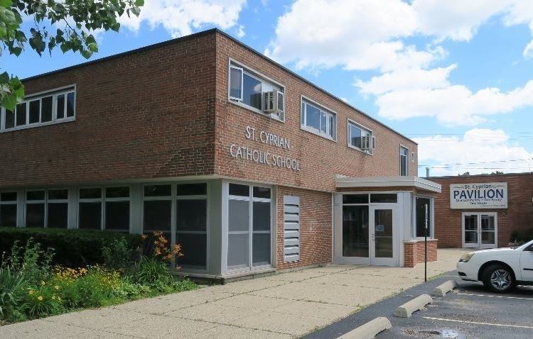 Exterior view of St. Cyprian school 's brick facade and south entrance