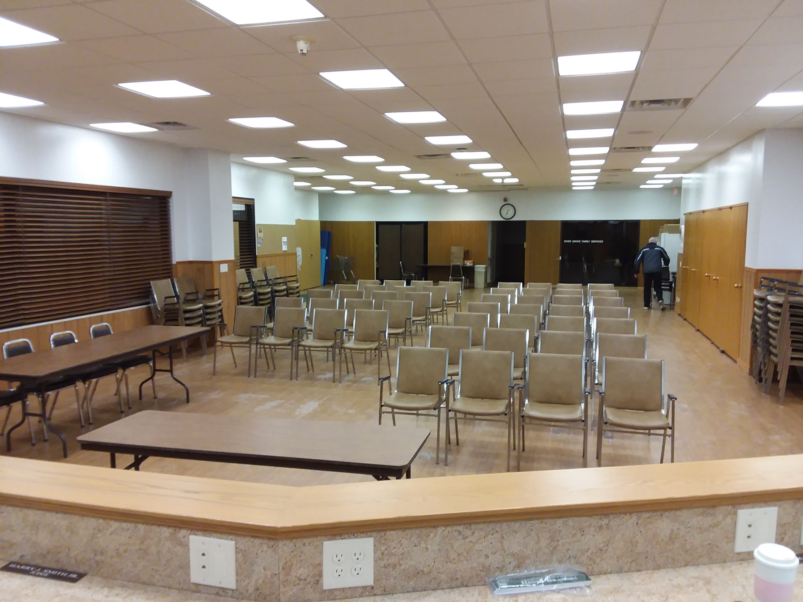 Interior view of Wolf Community Center with 50 chairs set up on the wooden floor