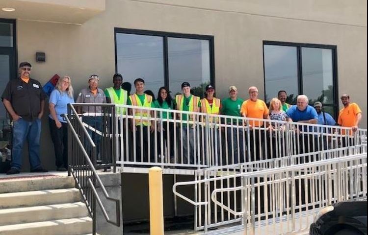 Public Works employees gathered together along a railing