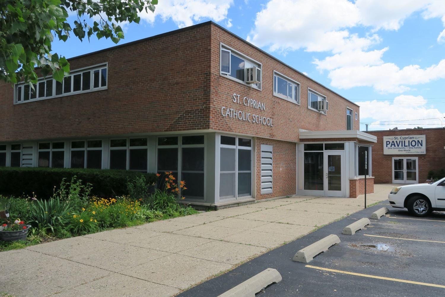 Exterior view of St. Cyprian school ’s brick facade and south entrance